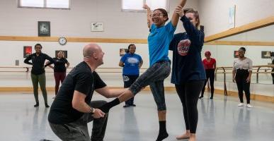 Instructor assists dance student at Pre-Collegiate Summer Dance Intensive.