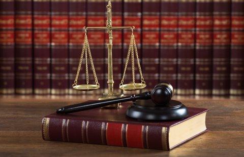 Mallet And Legal Book With Justice Scale On Table