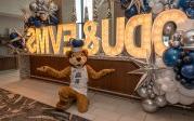 ODU's mascot poses in front of an ODU/EVMS sign. 